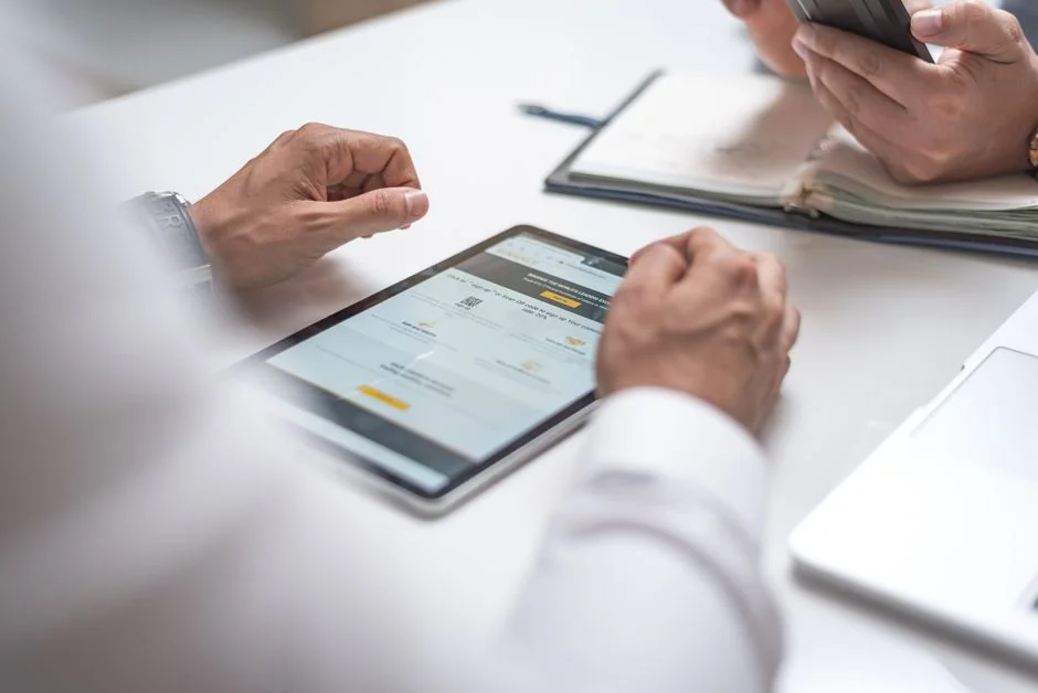 who-we-are A refined workspace with a laptop and monitors running design software.